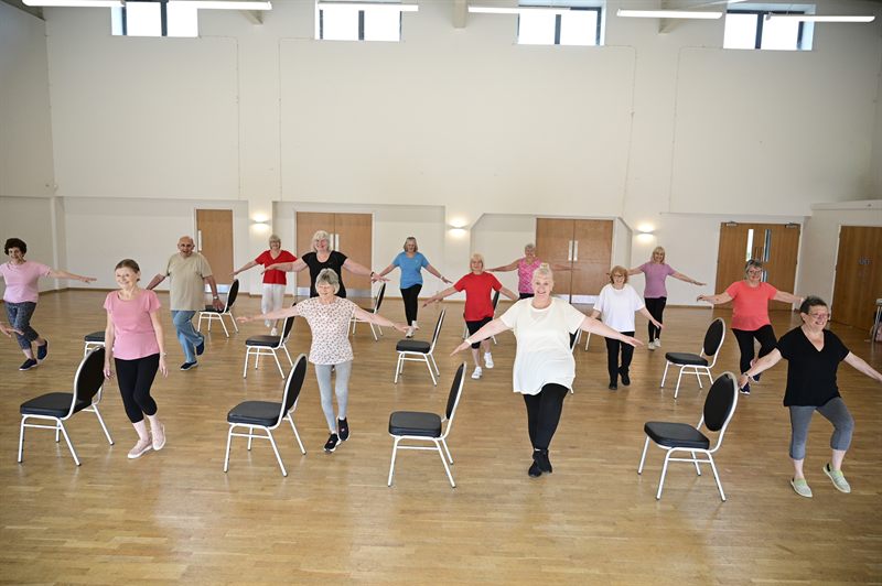 Members practising balance exercises